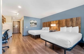 Desk, iron/ironing board, bed sheets