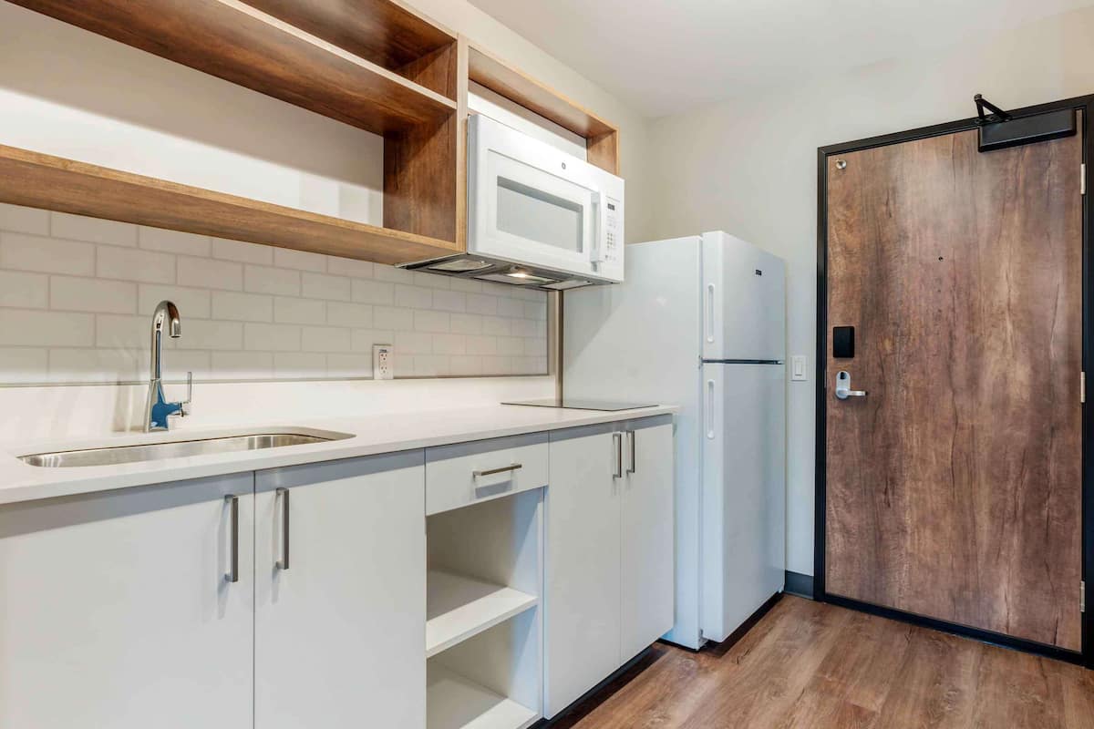 desk, iron/ironing board, bed sheets