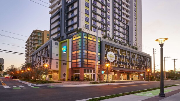 A multi-story hotel with a modern design, featuring a prominent 'TRU' sign on the ground floor. - Tru by Hilton Fort Lauderdale Downtown (Fort Lauderdale)