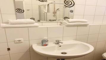 Shower, towels, soap, toilet paper