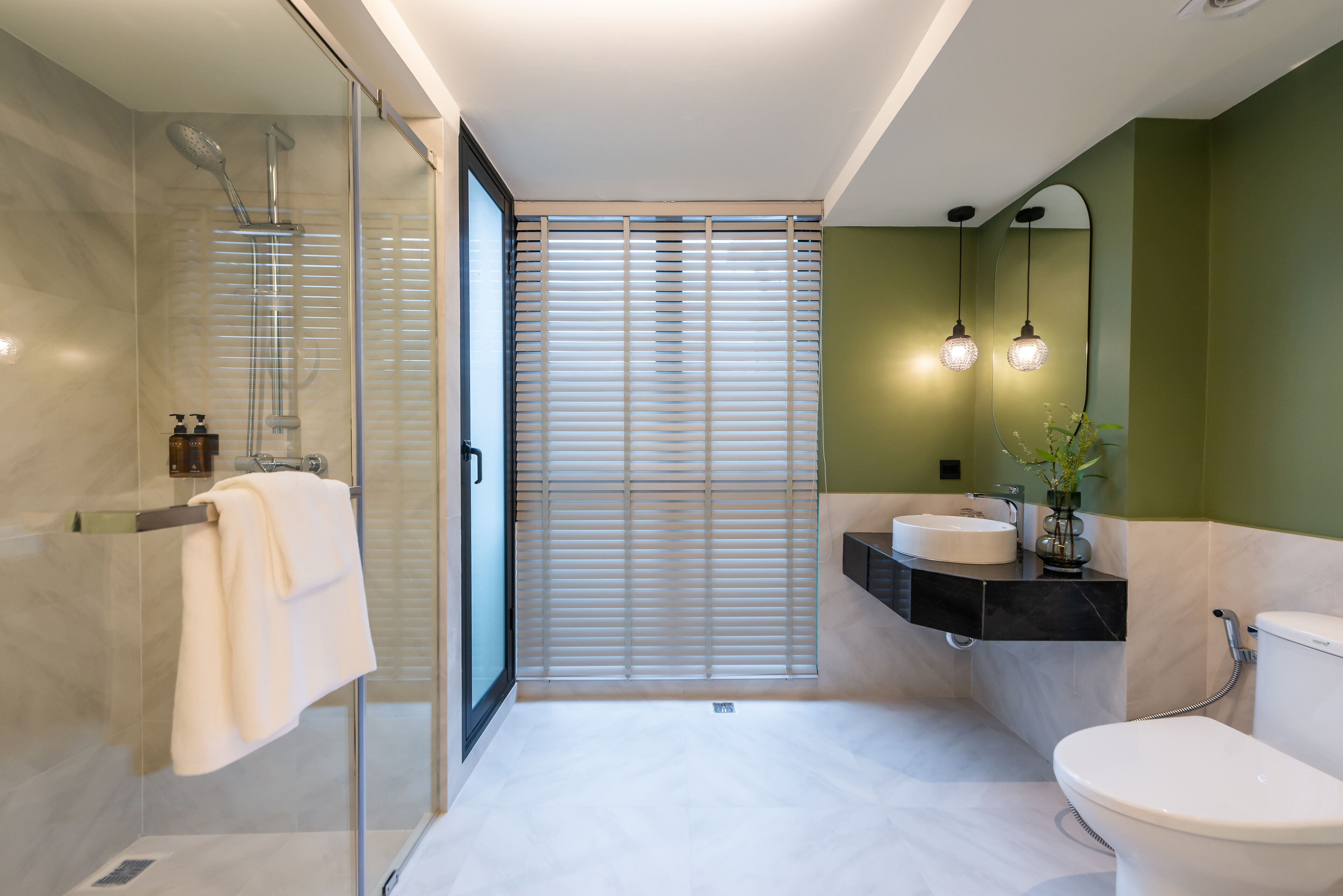 Une salle de bain moderne avec une douche à parois de verre, des toilettes et un lavabo avec un meuble-vasque.