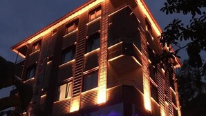 A multi-story building with a modern architectural design, featuring balconies and large windows. - Vulada Butik Otel (Ardesen)