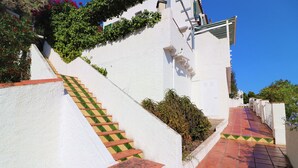 A staircase with green and yellow patterned steps leading up a white wall. - MALLORCA 8 Canyelles Roses (Rosas / Roses)