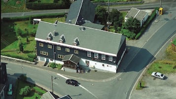 Two-story building with a central entrance and symmetrical facade.