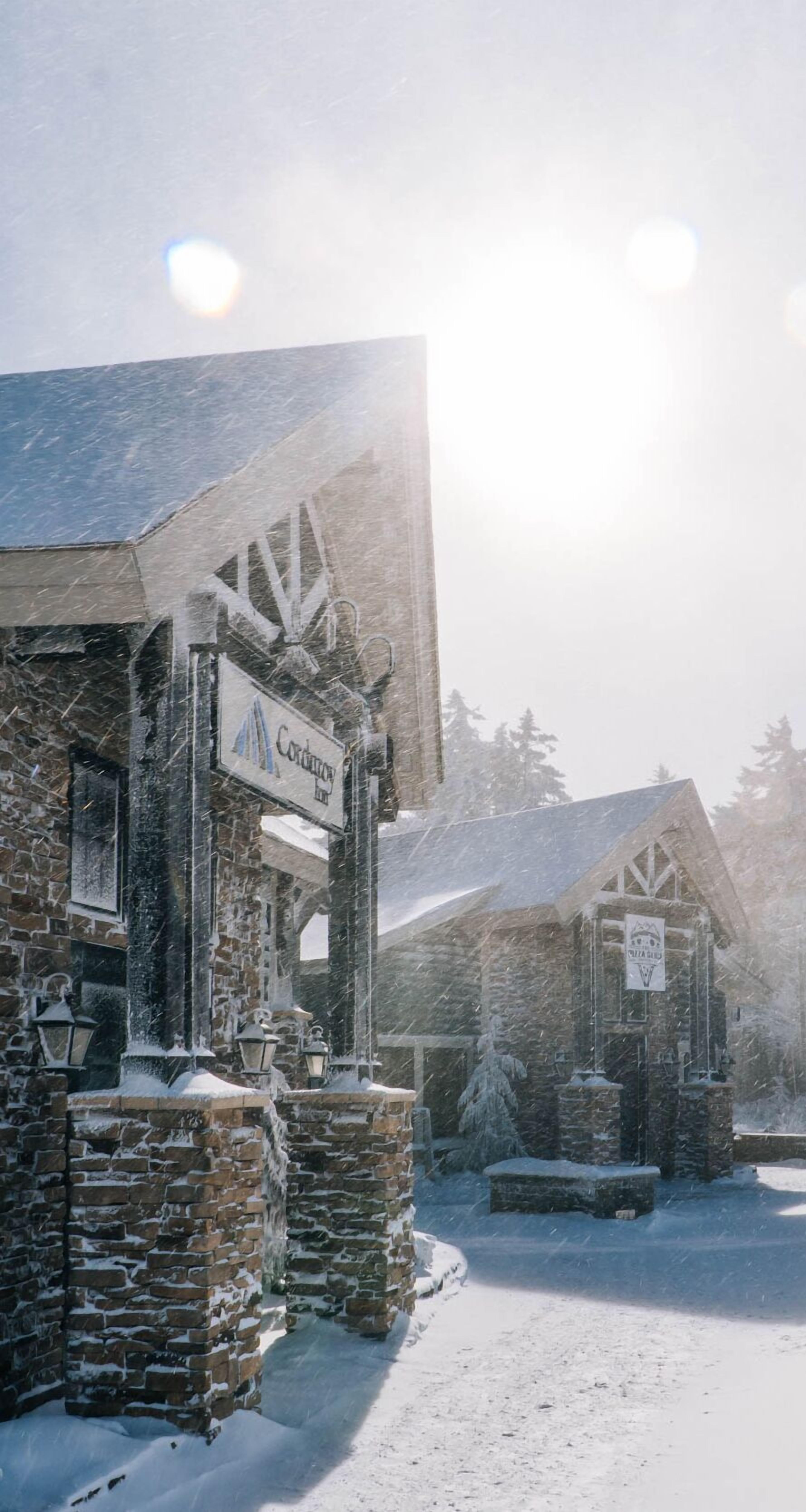 A snow-covered building with a sign that reads "Condor Inn".