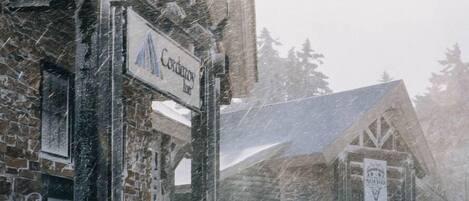 A snow-covered building with a sign that reads "Condor Inn".