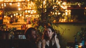A dimly lit indoor setting with tables and chairs, suggesting a dining or social area. -  Straw Hat Tulum (Tulum)