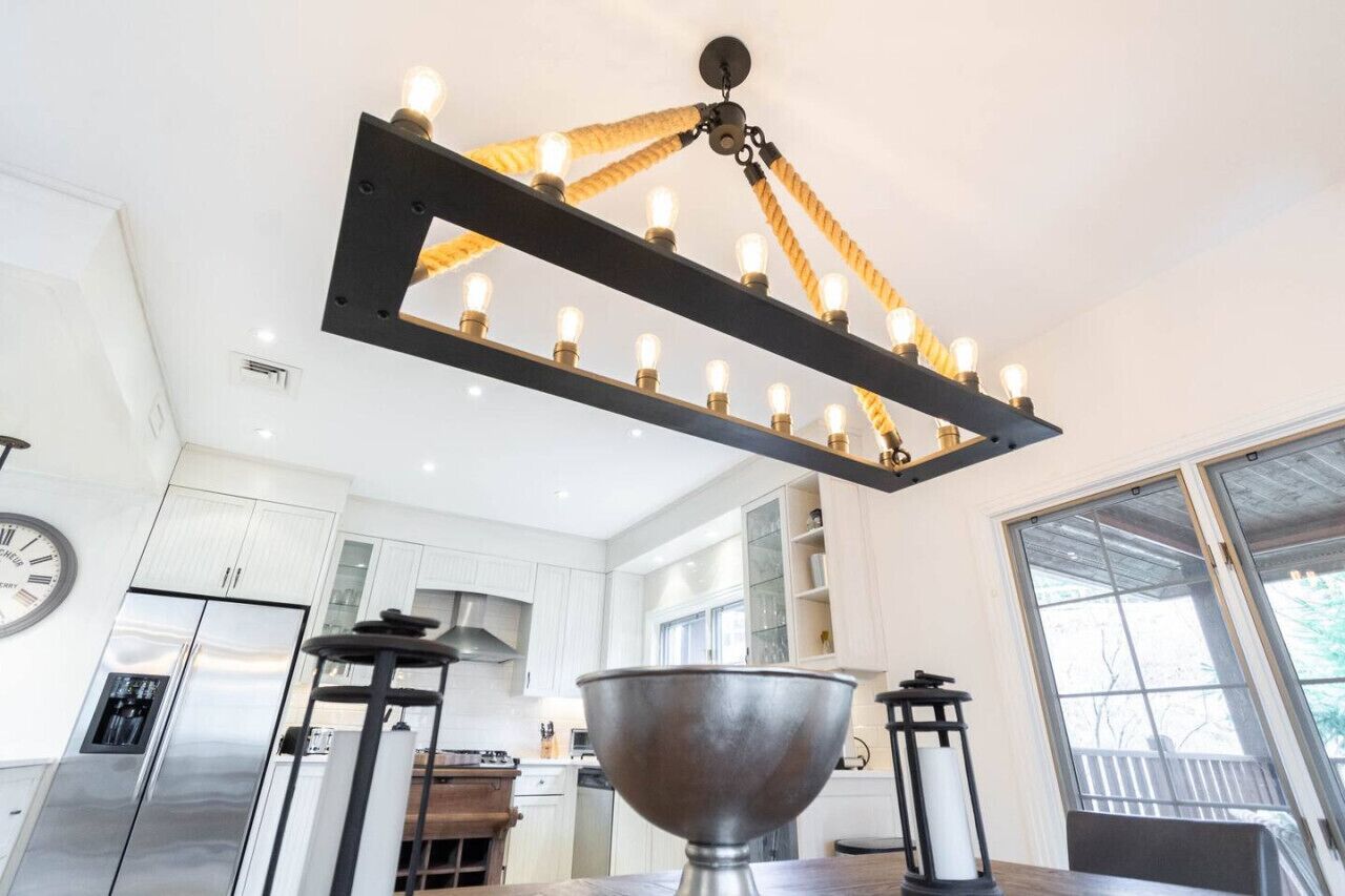 A modern kitchen with white cabinets, stainless steel appliances, and a large metal bowl on the counter.