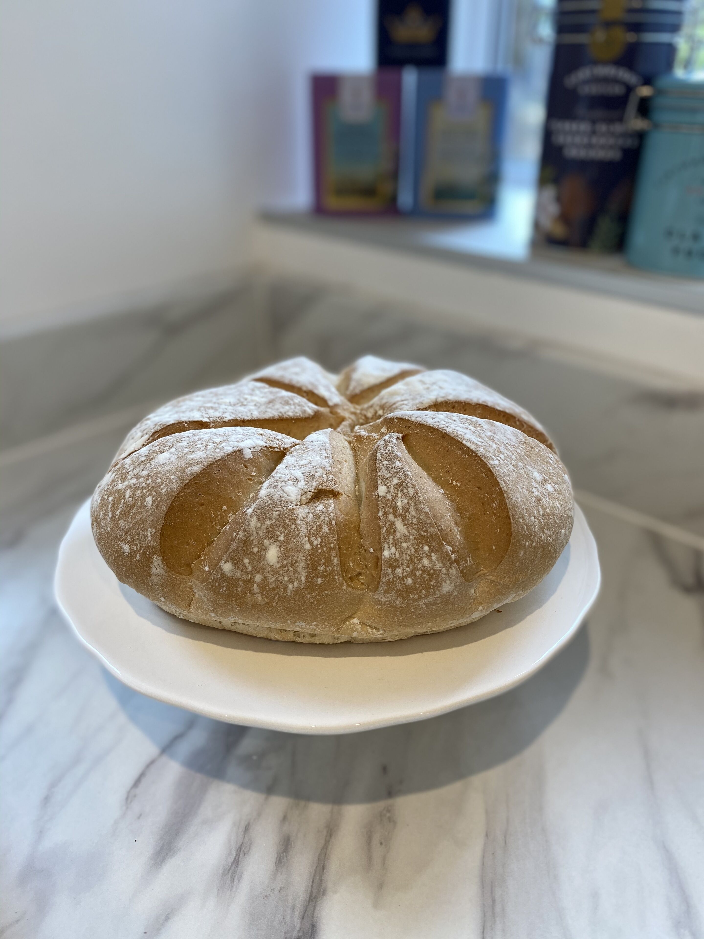 A loaf of bread on a white plate.