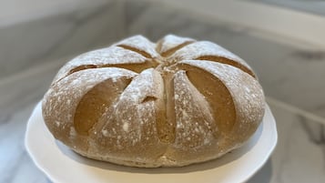 A loaf of bread on a white plate.