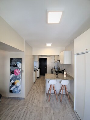 Fridge, microwave, coffee/tea maker, cookware/dishes/utensils