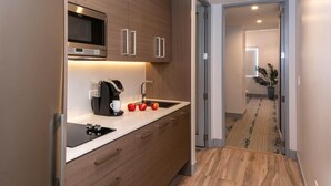 A modern kitchen with a built-in microwave, a coffee maker, and a sink. - 2 Bedroom, Sleeps 6 Guests (Cruz Bay)