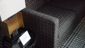 A check-in area with a black and white checkered floor, a black table with a glass top, and a sign that reads "Union Club Hotel."