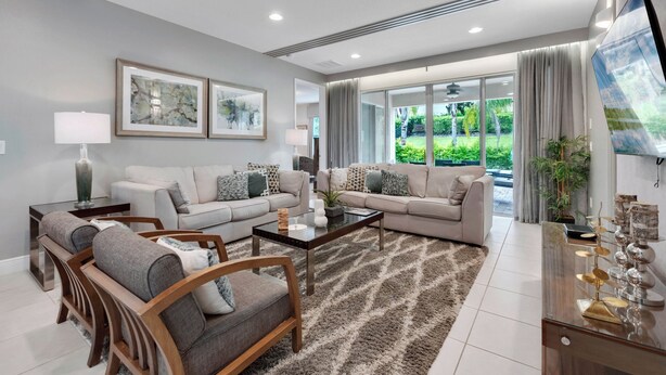 A modern living room with two sofas, a coffee table, and a TV. - 6 Bedrooms/ 6.5 Bathrooms/ Encore (7514 MA) (Kissimmee)