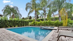 A rectangular swimming pool with a tiled edge, surrounded by a brick patio. - 6 Bedrooms/ 6.5 Bathrooms/ Encore (7514 MA) (Kissimmee)