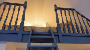 A bunk bed with a ladder, a headboard, and a pillow with a cat design. - Claymires Bothy Cottage Nr Loch Lomond & Stirling (Stirling)