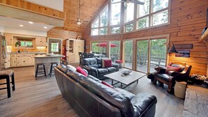 Un intérieur de cabine spacieux comprenant un grand espace de vie, une cuisine et un coin repas.