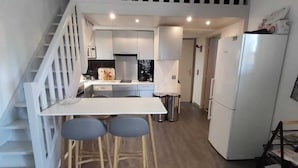 A modern kitchen with a central island, a staircase, and a white refrigerator. - House ⭐️⭐️⭐️⭐️⭐️ Family only Gassin-St Tropez dream  (Gassin)