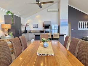 A modern kitchen with a dining area. - House 23 - Seahorse Dunsborough (Dunsborough)