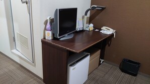 A hotel desk with a computer, phone, and a small refrigerator. - Business Hotel Goto (Kure)