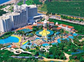 A resort with a large central pool, multiple smaller pools, and a variety of water slides.