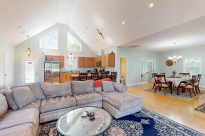 Relax in a spacious living area with a large L-shaped sofa and glass coffee table.