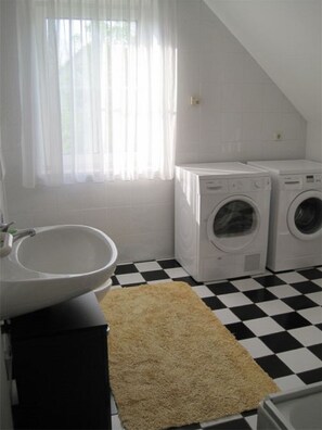 Huis | Badkamer | Een douche, een haardroger, handdoeken, zeep