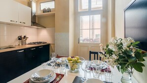 A modern kitchen with a dining area set for a meal. - APT in Center Prague by Michal&Friends (Prague)