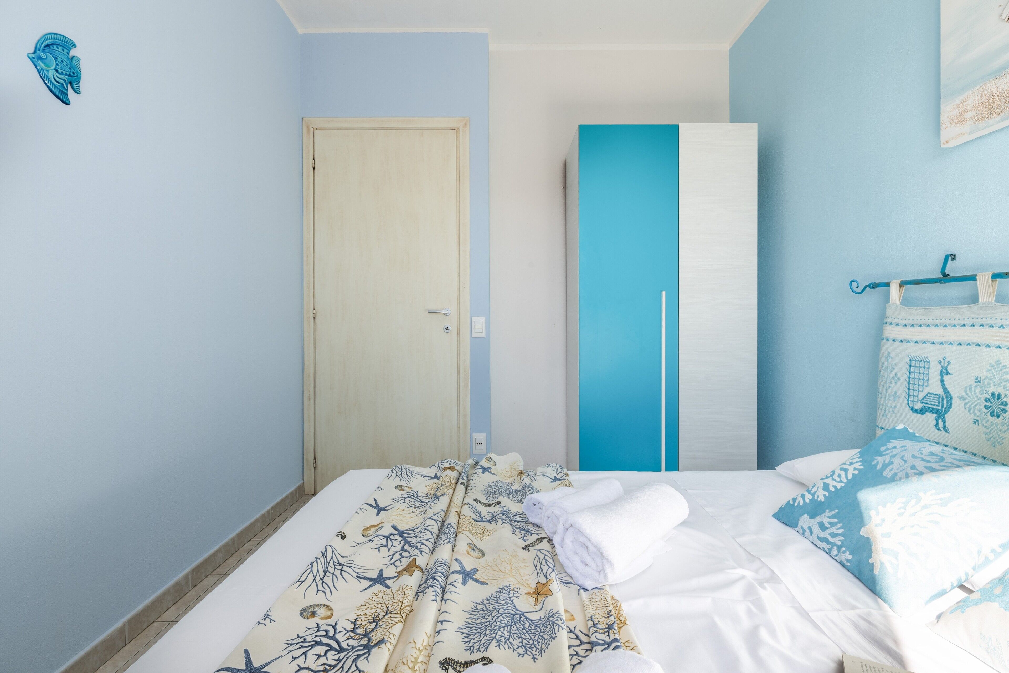 Una camera da letto con un letto, un armadio e una porta.