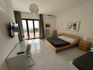 Superior Triple Room, Pool View | Desk, laptop workspace, blackout drapes, iron/ironing board - Villa Leucatia Bed&Events (Sant'Agata Li Battiati)