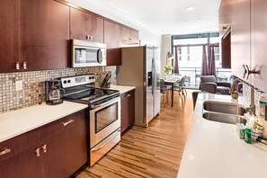 Fridge, microwave, oven, stovetop - Spacious Downtown Condo w/ Balcony by Lucky Savannah (Savannah)