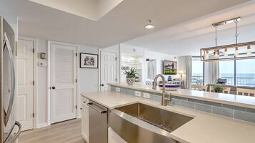 Fridge, dishwasher, coffee/tea maker, cookware/dishes/utensils
