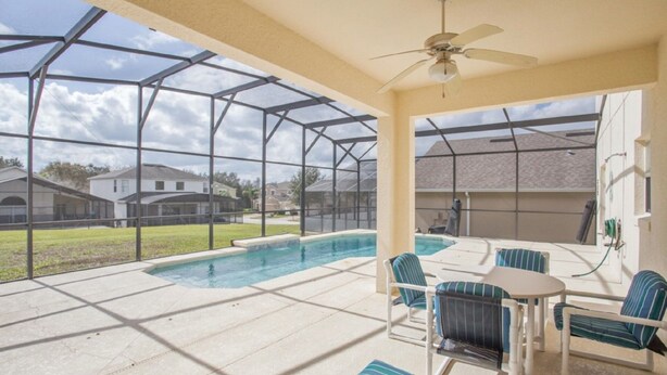 A covered outdoor area with a pool, patio furniture, and a ceiling fan. - South-Facing Private Pool • 2 Ensuites • 15 Minutes to Disney (Davenport)