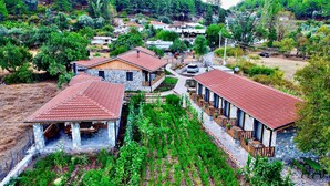A rural property with stone buildings, a vineyard, and a winding road. - Dedehan Retreat Otel (Fethiye)