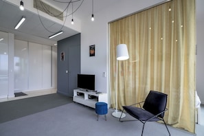 Exclusive Apartment | Living area | 30-inch TV with cable channels