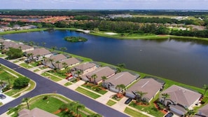 A residential area with houses, a lake, and a golf course.