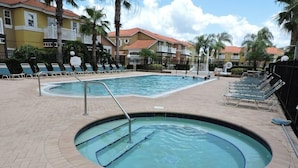 A swimming pool area with lounge chairs and a hot tub. - Ref E Luxury 4 Bed Villa With Private Pool Near Disney (Kissimmee)