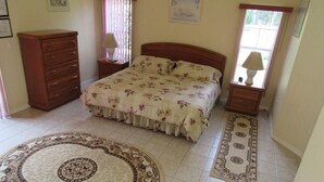 A bedroom with a bed, a dresser, two bedside tables, and a rug. - Ref 24 Modern 4 Bed Villa With own South Facing Pool (Kissimmee)