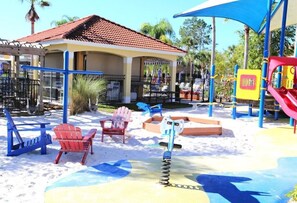 Relax and play in this outdoor space with a pavilion, slide, swings, and play structure.