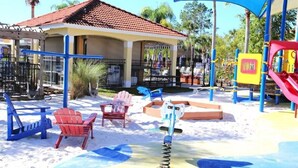 A playground with a slide, swings, and a covered seating area. - Ref 28 Stunning 4 Bed Villa With own Pool on Gated Resort (Kissimmee)