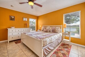 A bedroom with a bed, a dresser, a nightstand, a ceiling fan, and a window with blinds. - Ref 05 Luxury 3 Bed Villa Completely Refurbished 2020 (Kissimmee)