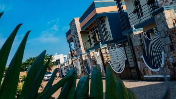 A modern two-story building with a stone facade and balconies. - Konga Hotel Kigali (Kigali)