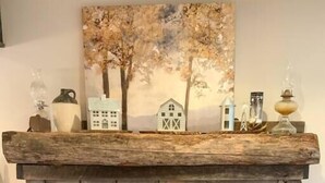 A stone fireplace with a mantel shelf displaying decorative items.
