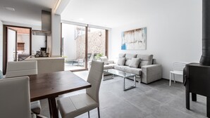 A modern living room with a dining area, a sofa set, and a fireplace. - BUGERA. Beautiful restored house in Pollensa (Pollensa)