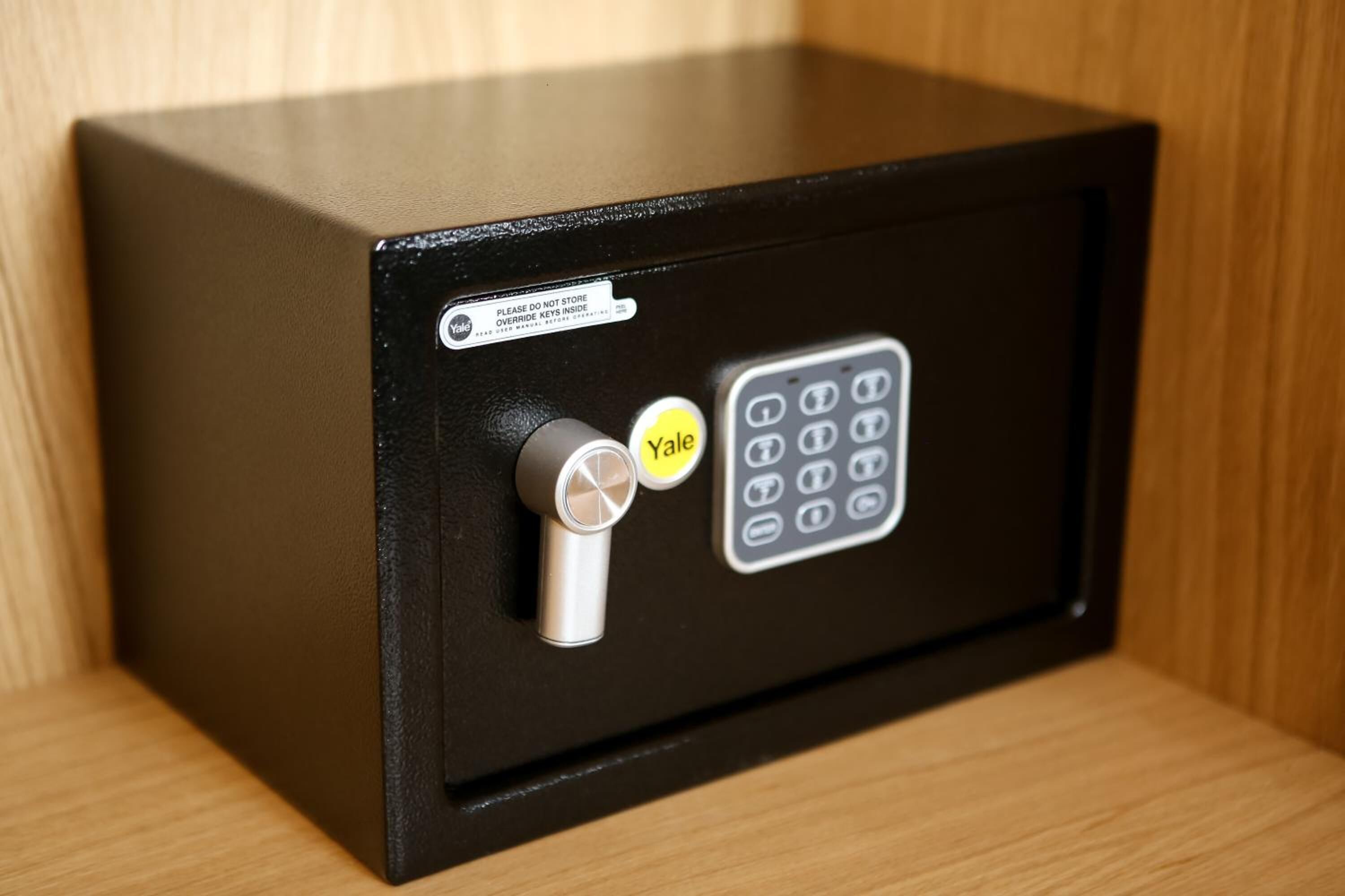 A black safe with a Yale lock and keypad.