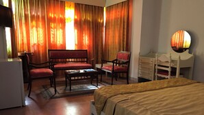 A hotel room with a bed, a desk, a chair, a sofa, and a dresser. - Hotel Residence Mahmoud (Hammamet)