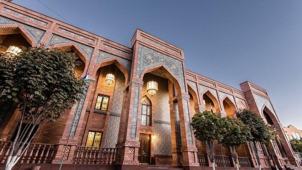 A hotel with a traditional architectural style, featuring arched windows and detailed brickwork.