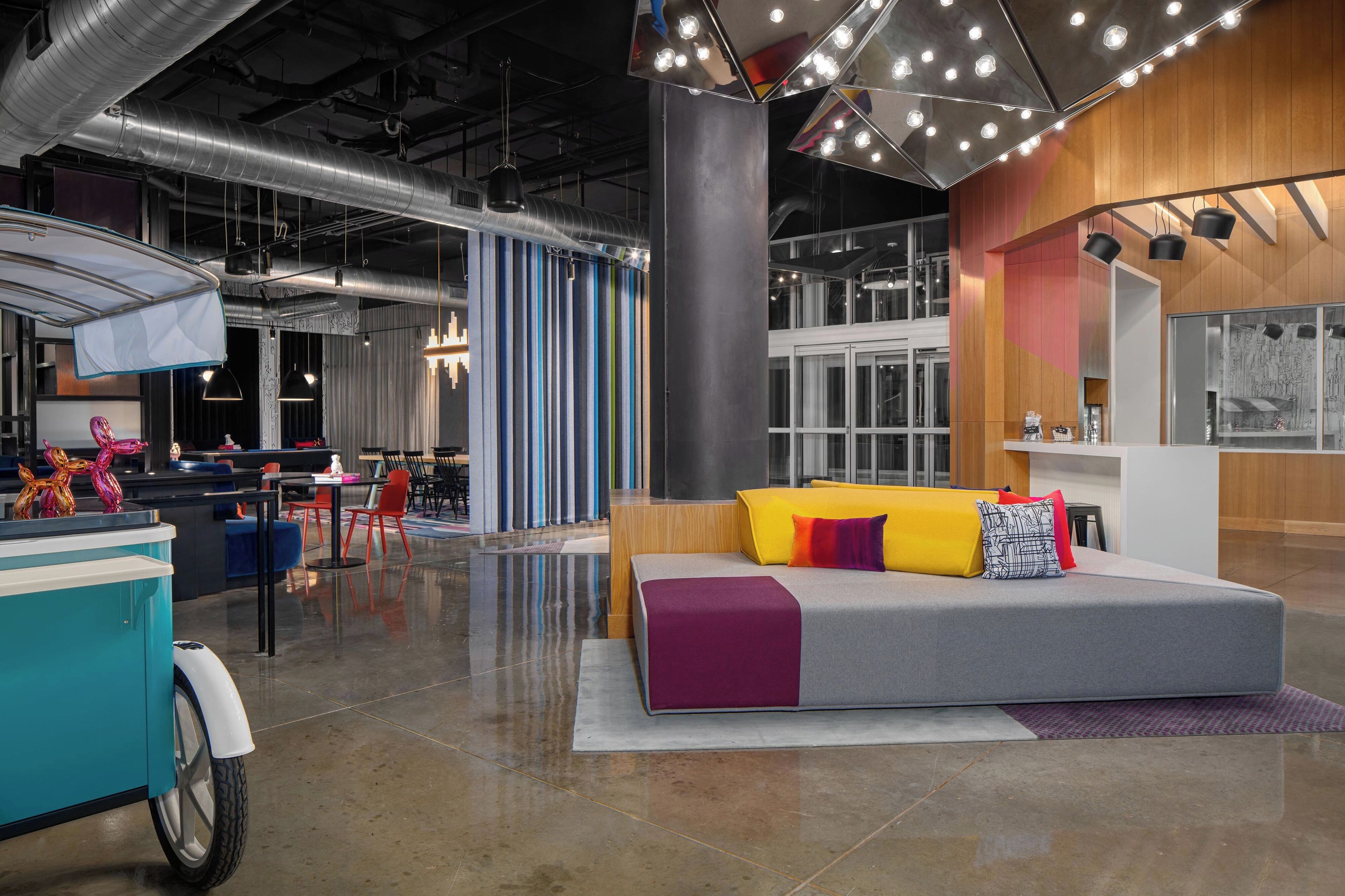 A modern interior with a seating area, tables, and chairs.