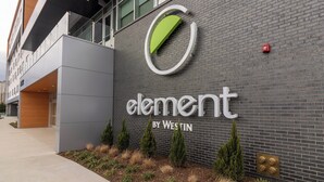 A building with a sign that reads "element by Westin" on a brick wall.