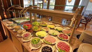 A buffet with various food items including salads, meats, and cheeses. - Golden Line (Varna)